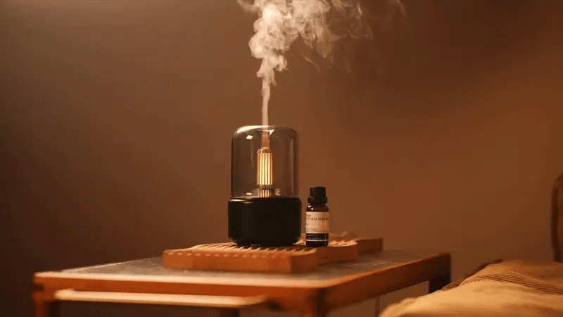 Kinscoter aroma diffuser glowing softly on a table, evoking a sense of calm and emotion.