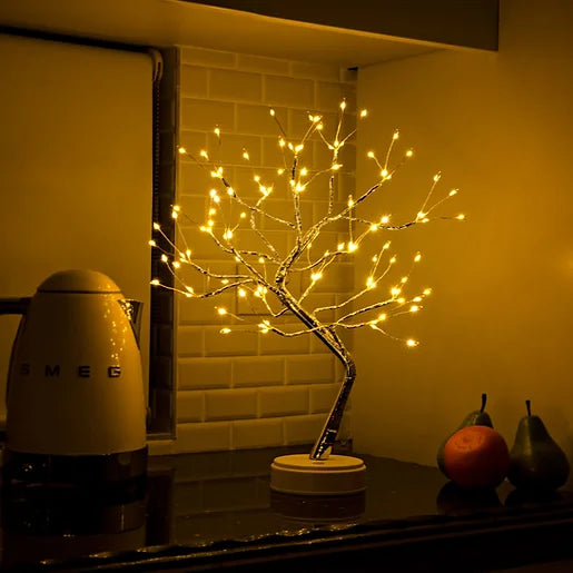 Decorative LED tree on a kitchen counter with a Smeg appliance in the background.